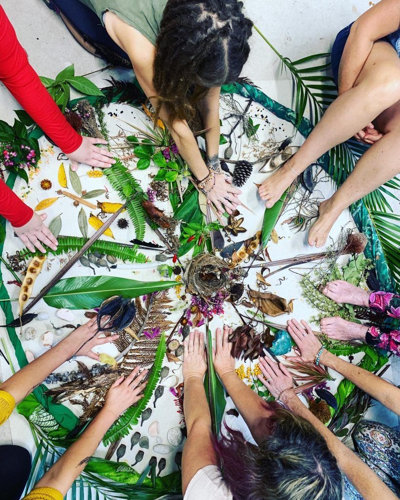 A group of women creating art using natural elements from gardens and landscapes.